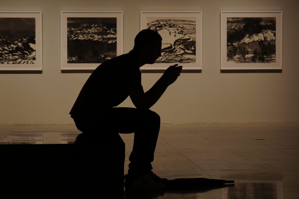 Man sitting in an art gallery.